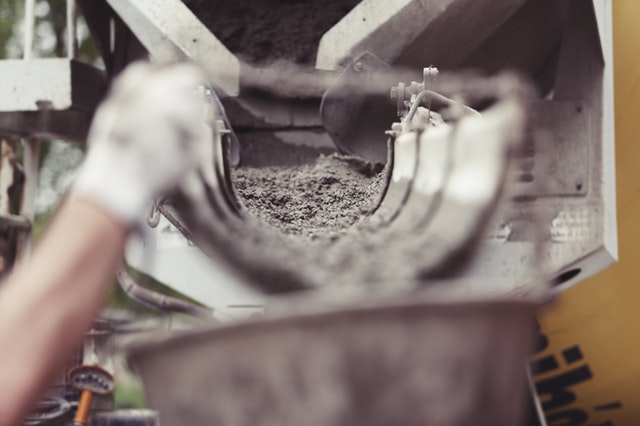 image of concrete being poured for swimming pool